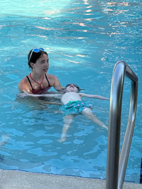 Teacher with Student in swimming class