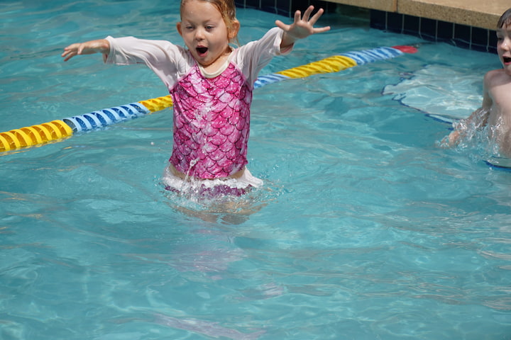 girl playing in swimming pool